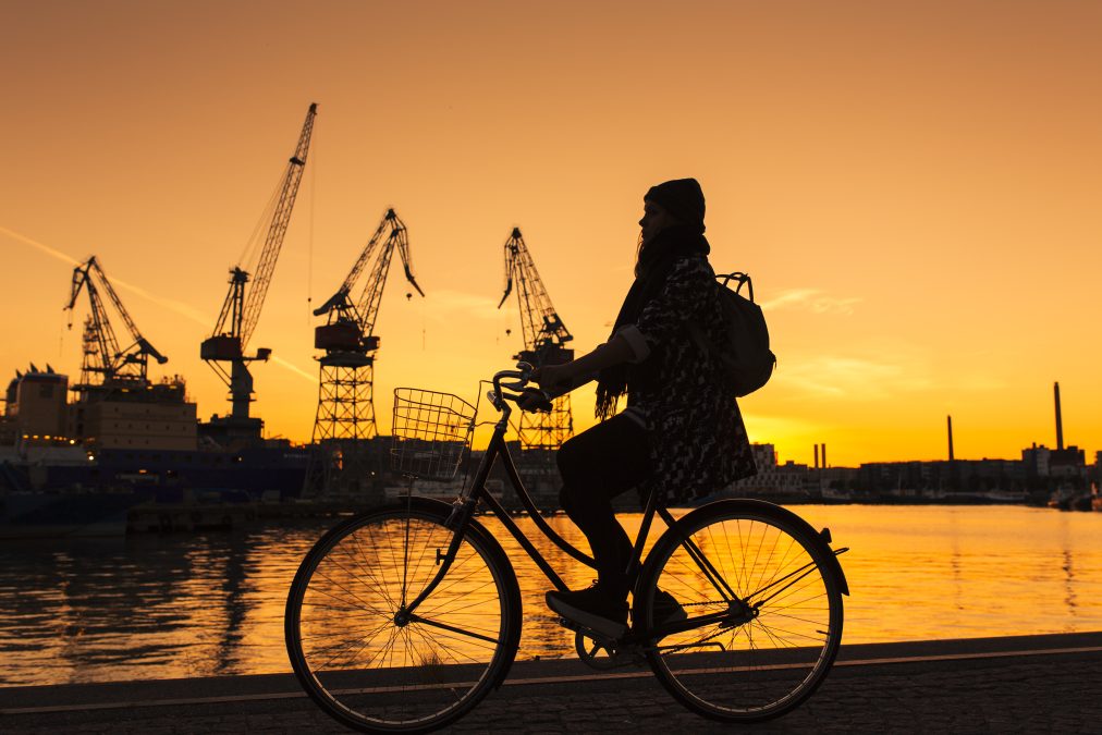 Cyclist by the sea at sunset